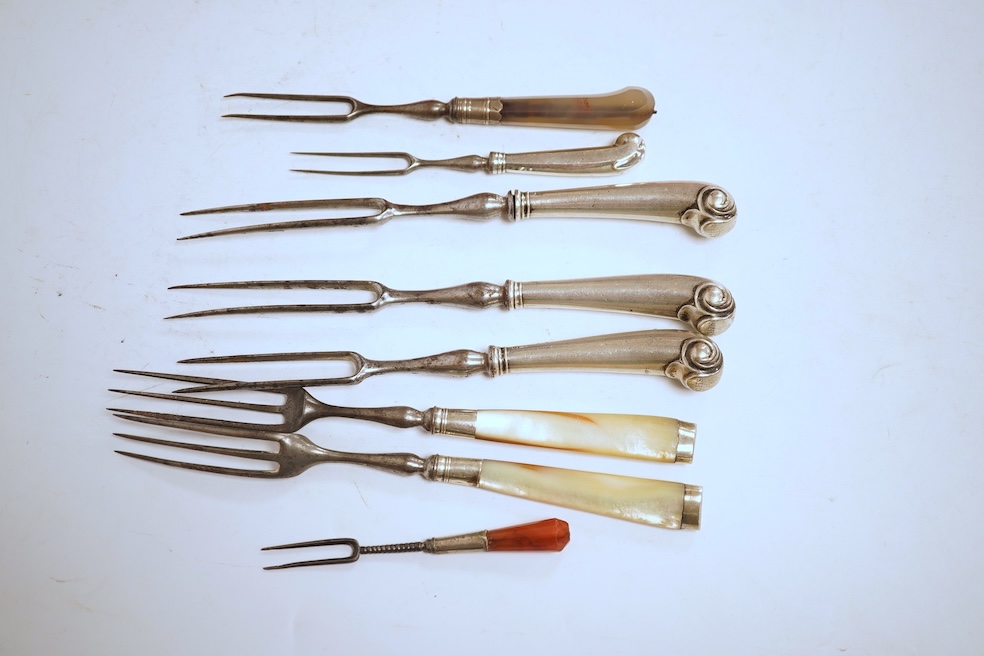 Five assorted George pistol handled steel pronged forks, four with white metal handles and one with agate handle, together with two similar mother of pearl handled steel pronged forks, largest 20.5cm and a small agate ha